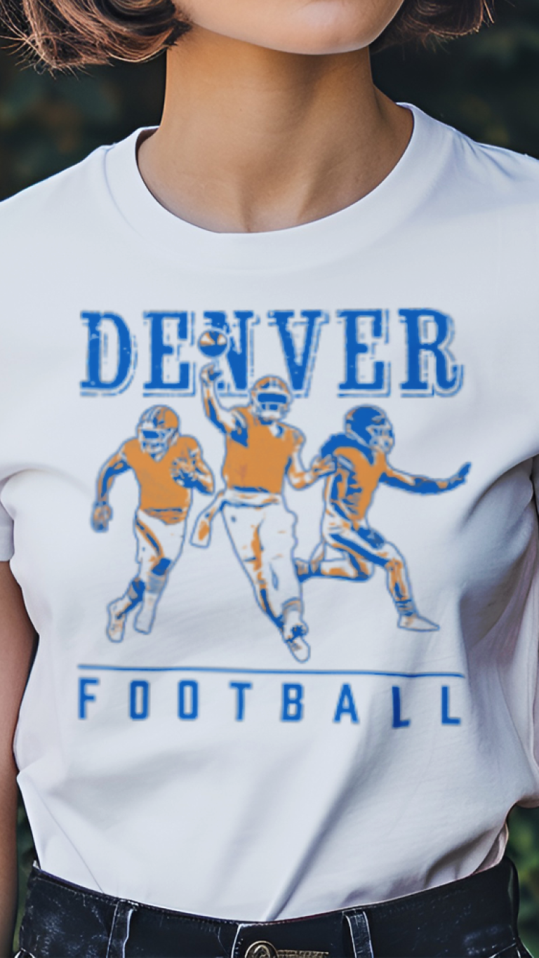 Person wearing a white t-shirt with 'Denver Football' graphic design outdoors.