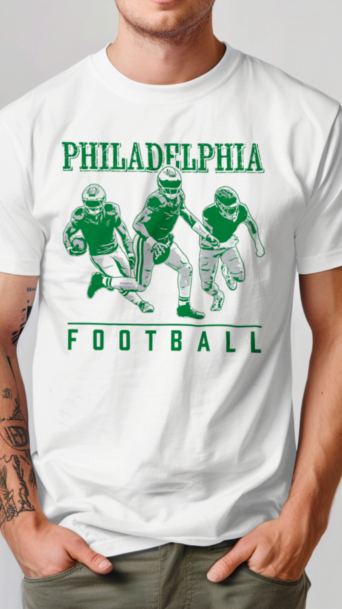 White t-shirt with green Philadelphia football graphics on a plain background