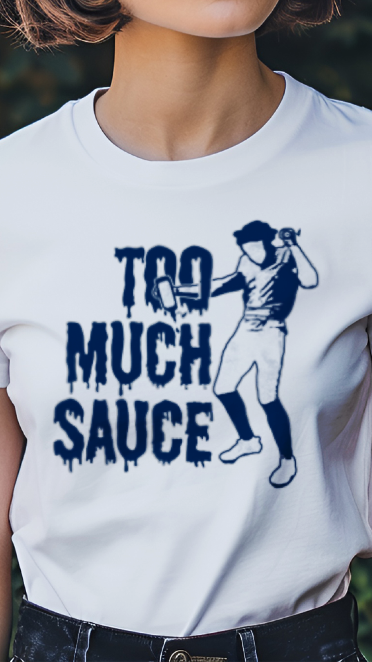 Person wearing a white t-shirt with a graphic and text 'Too Much Sauce' in a garden setting