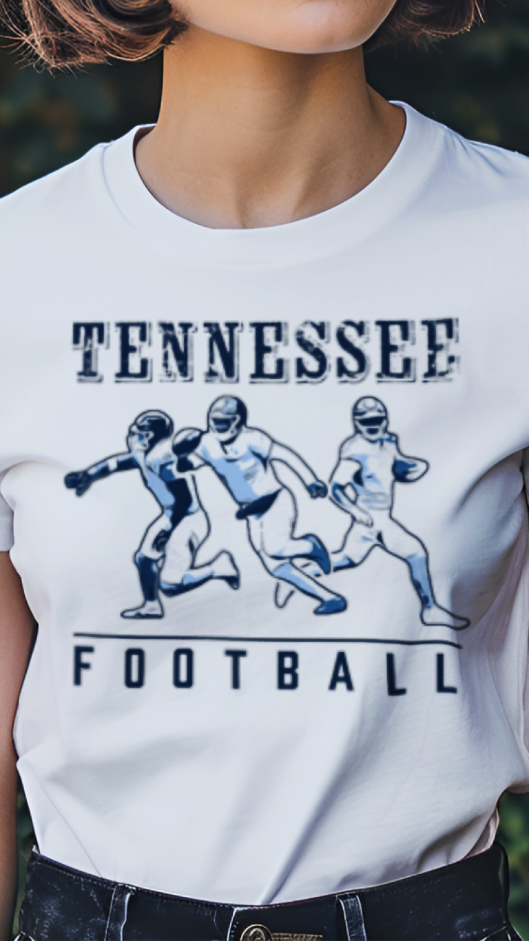 Person wearing a white t-shirt with 'Tennessee Football' graphic in a garden setting