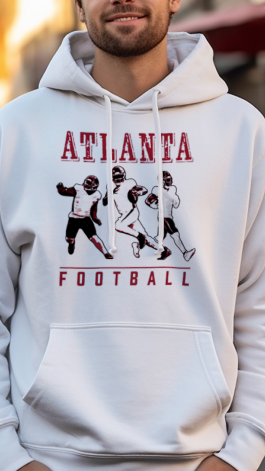 Man wearing a white hoodie with 'Atlanta Football' design on a street background