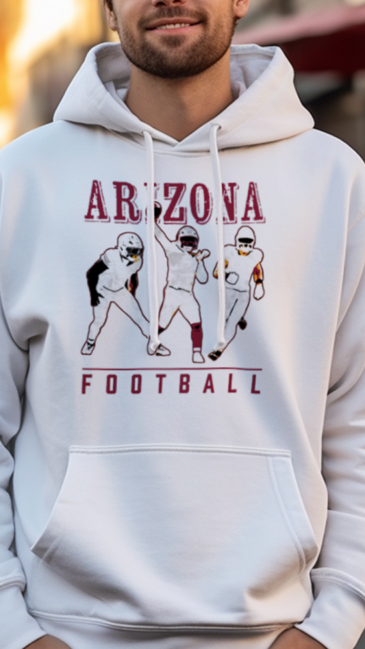 Person wearing a white hoodie with 'Arizona Football' design on a street.