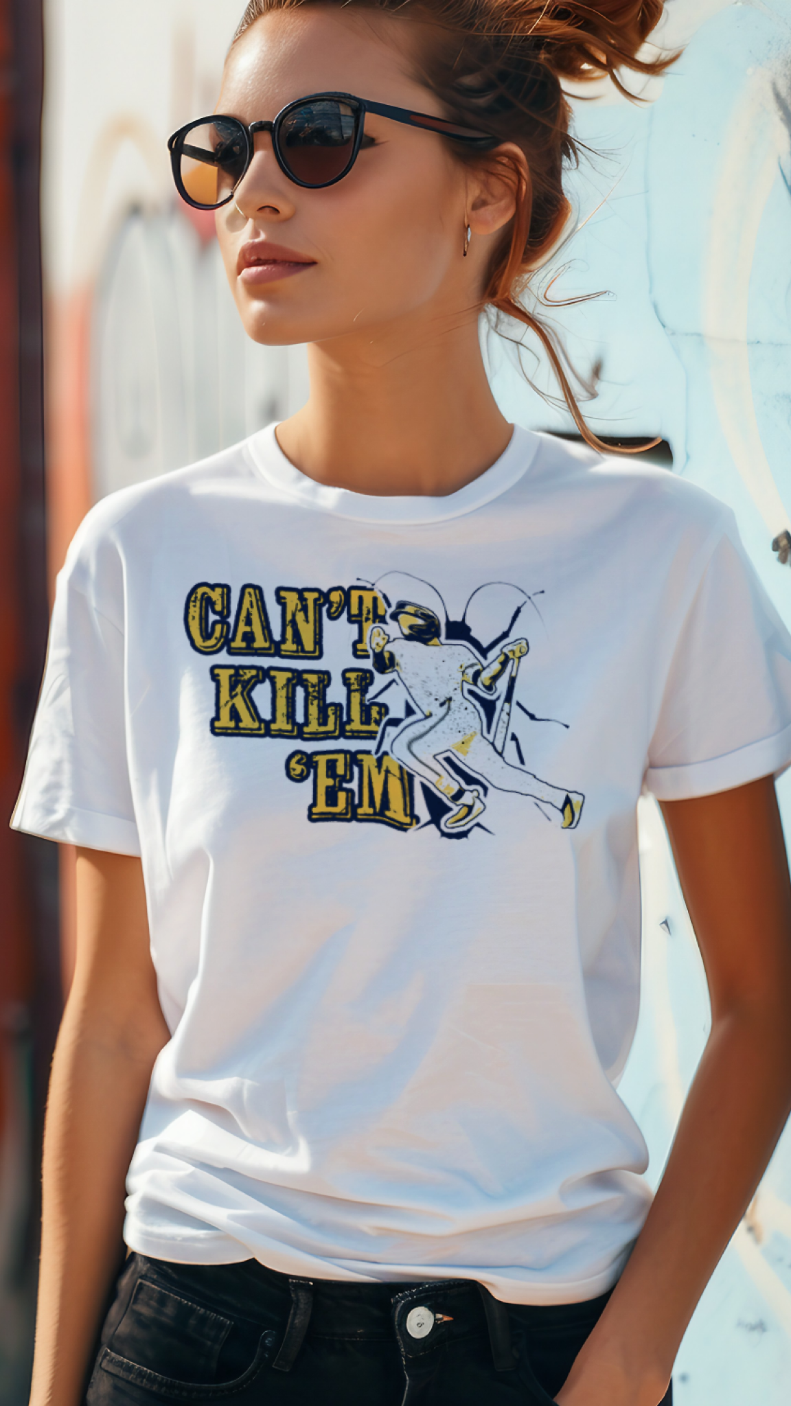 Woman wearing a white t-shirt with a graphic design and text, standing against a graffiti-covered wall.