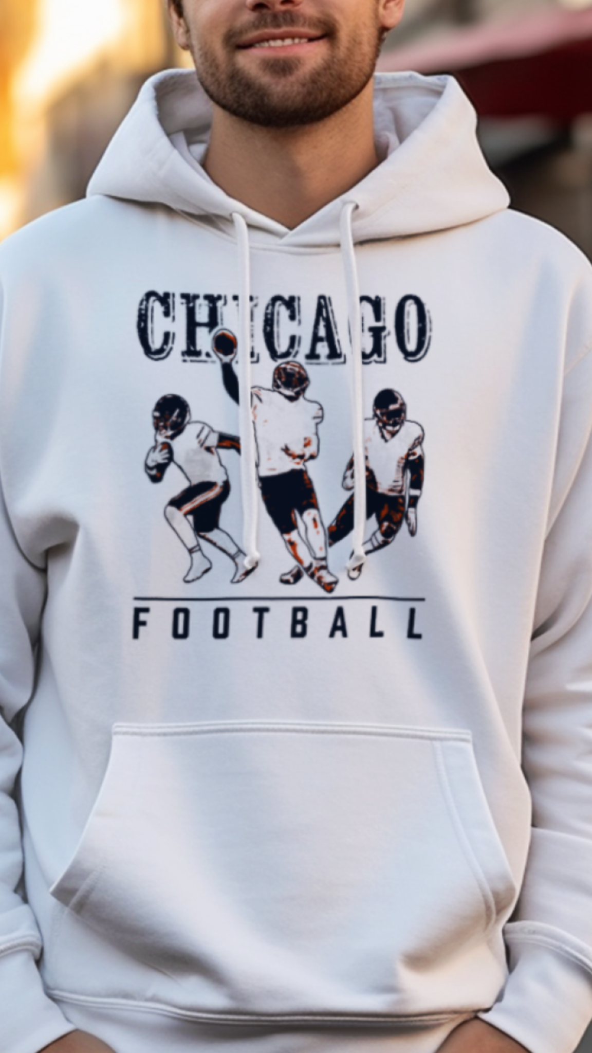 Man wearing a white hoodie with 'Chicago Football' graphic on a street background