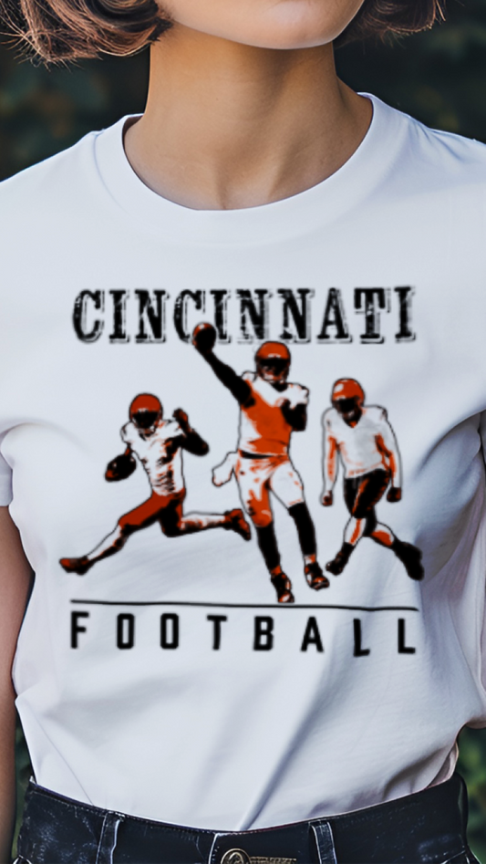 Person wearing a white t-shirt with Cincinnati football design against a floral background
