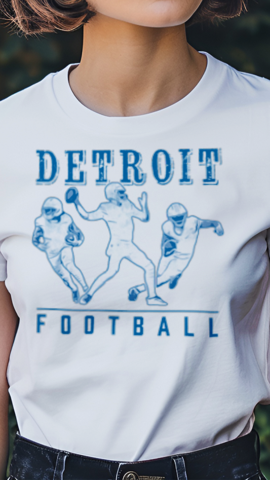 Person wearing a white t-shirt with 'Detroit Football' design outdoors.