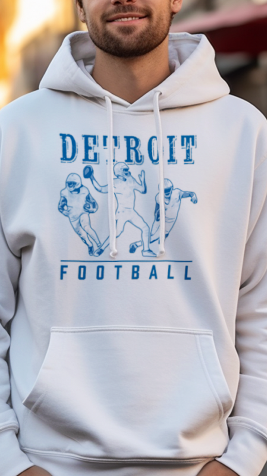 Man wearing a white hoodie with 'Detroit Football' design on a street background