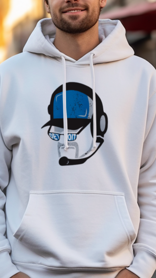 Man wearing a white hoodie with a graphic design on a street background