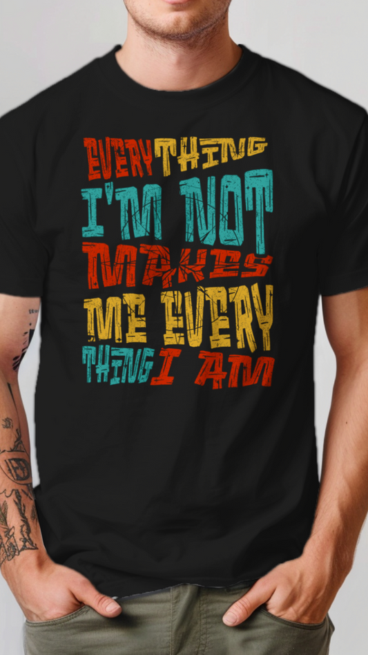 Person wearing a black t-shirt with colorful text design on a plain background