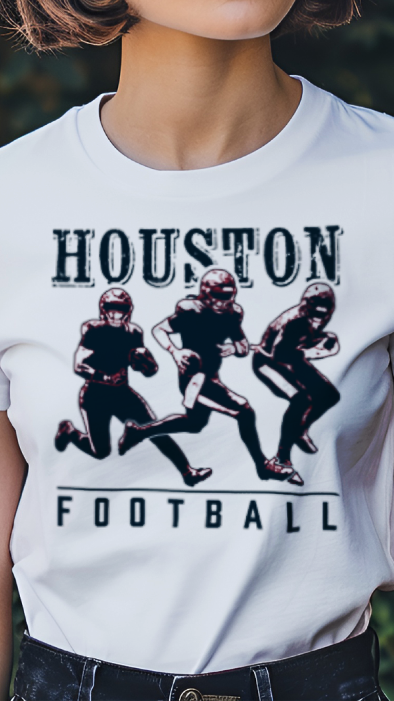 Person wearing a white t-shirt with 'Houston Football' graphic design outdoors.