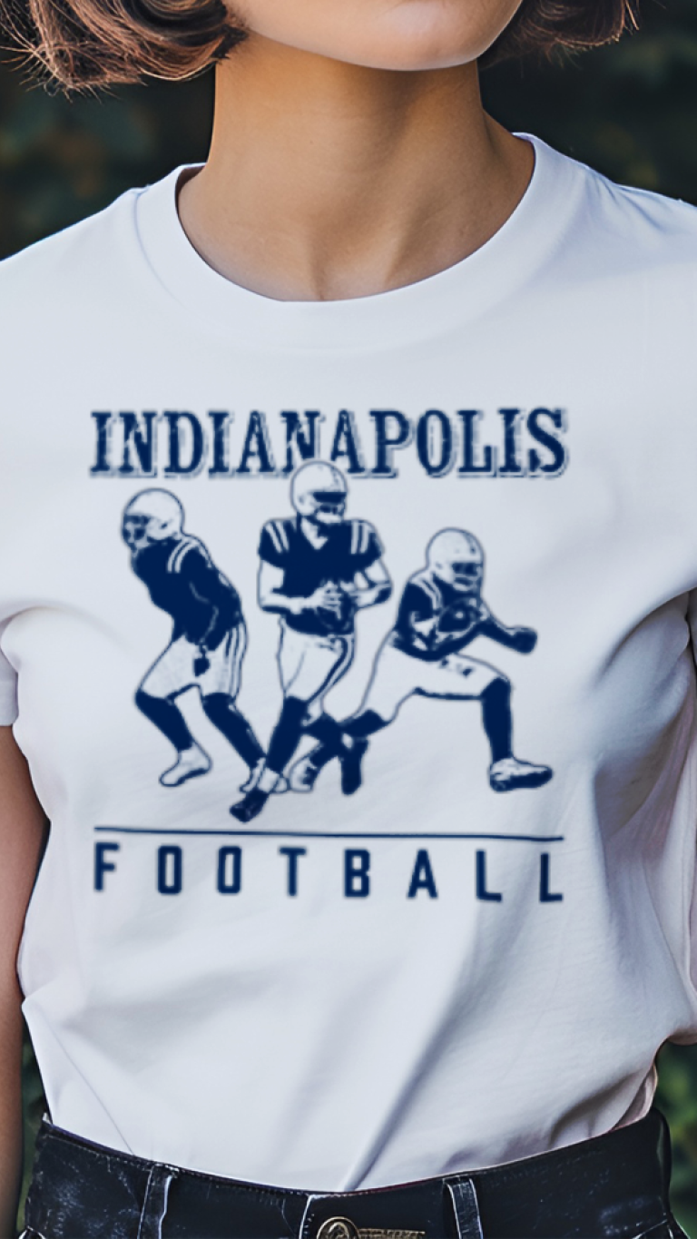Person wearing a white t-shirt with 'Indianapolis Football' design outdoors.