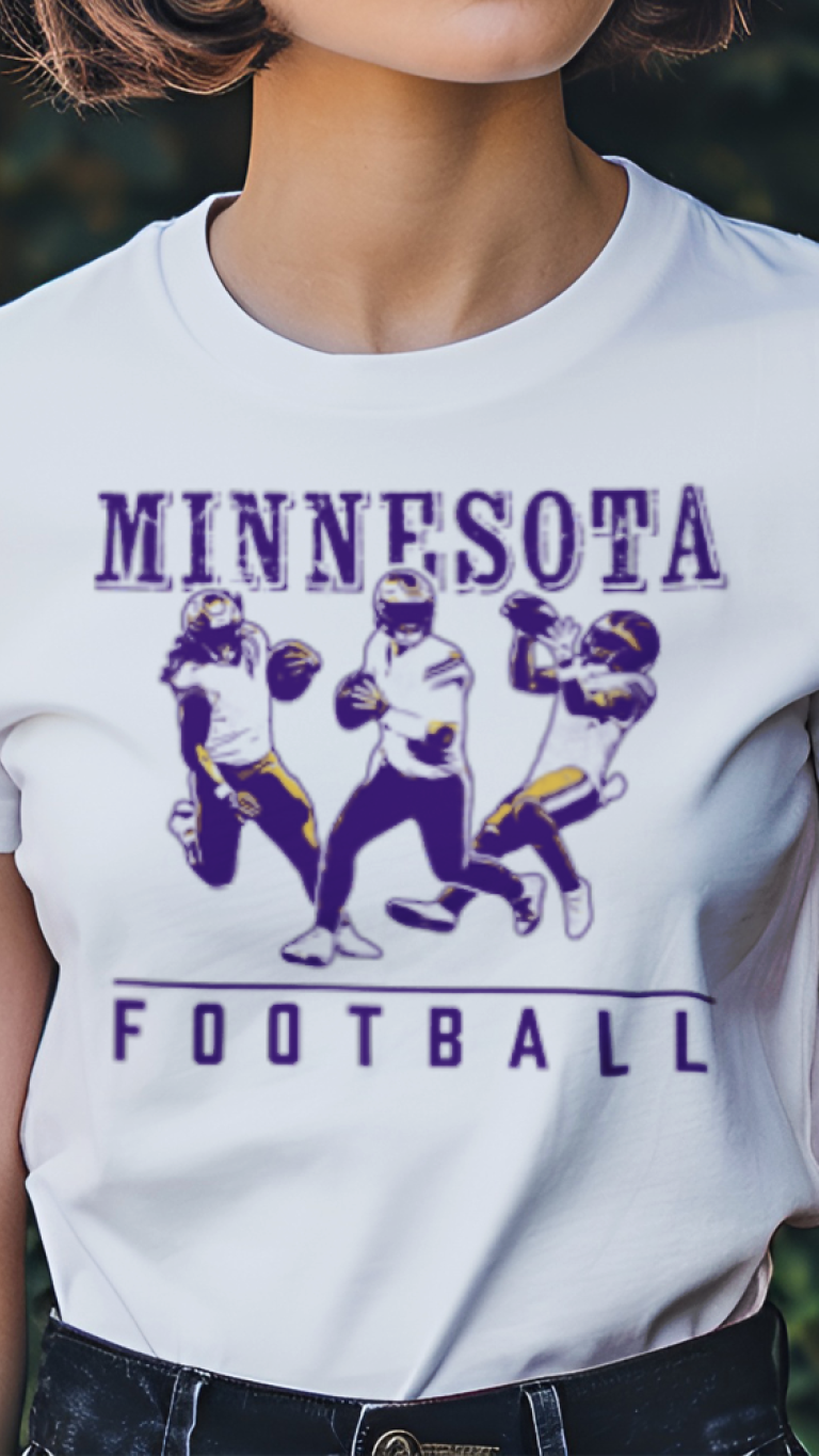 Person wearing a white t-shirt with 'Minnesota Football' design outdoors.