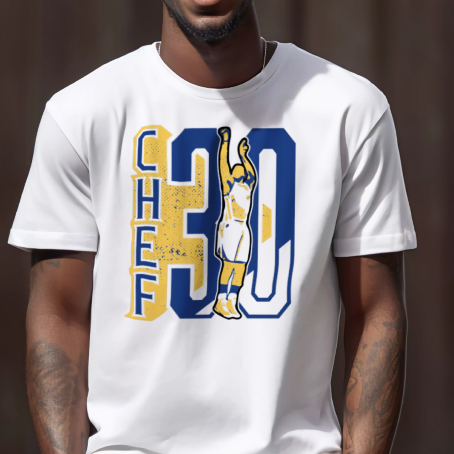 Man wearing a white t-shirt with a graphic design, standing against a brown wall.