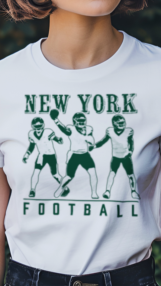 Person wearing a white t-shirt with 'New York Football' graphic in a garden setting