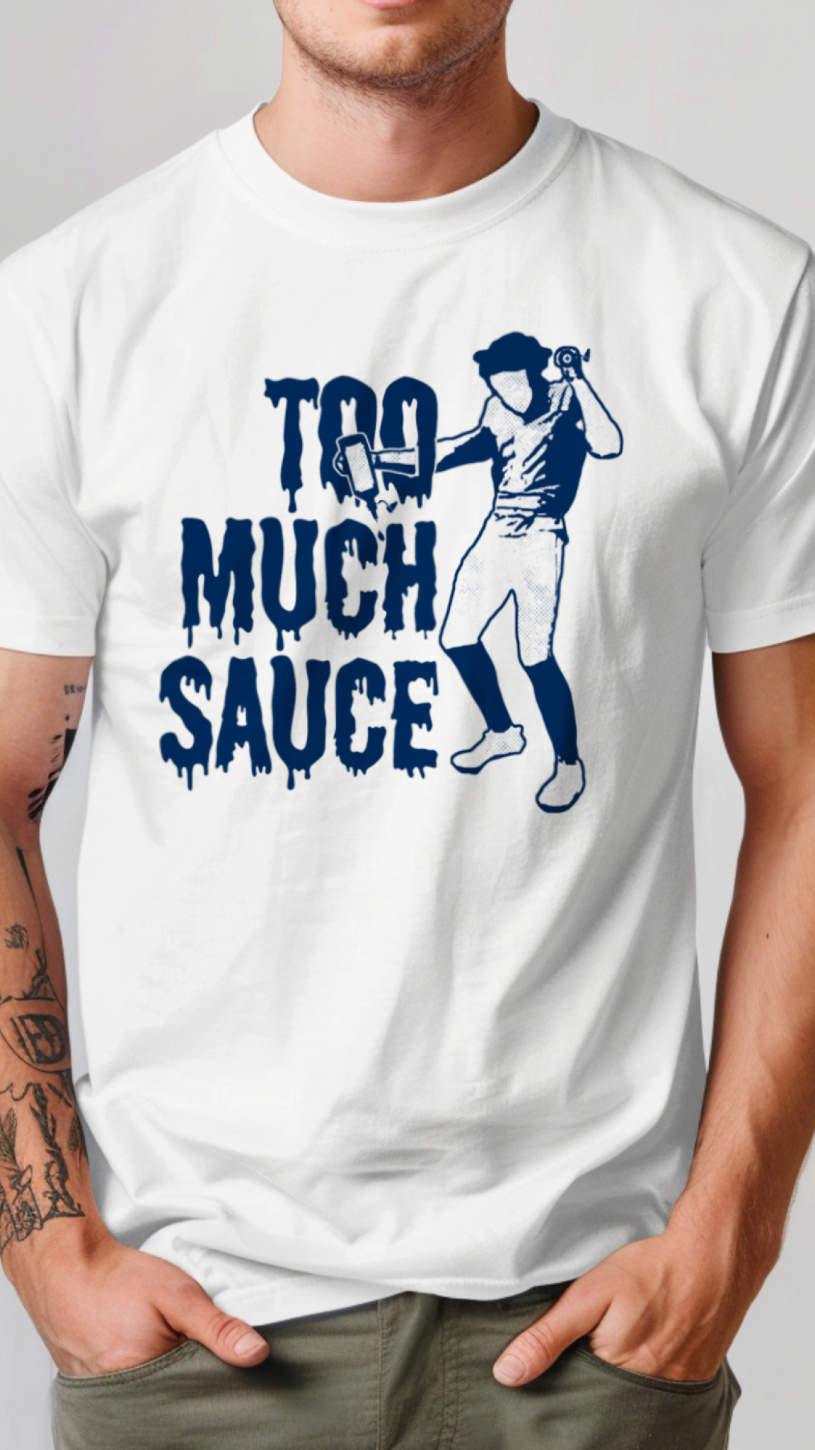 White t-shirt with blue graphic and text 'Too Much Sauce' worn by a person on a plain background