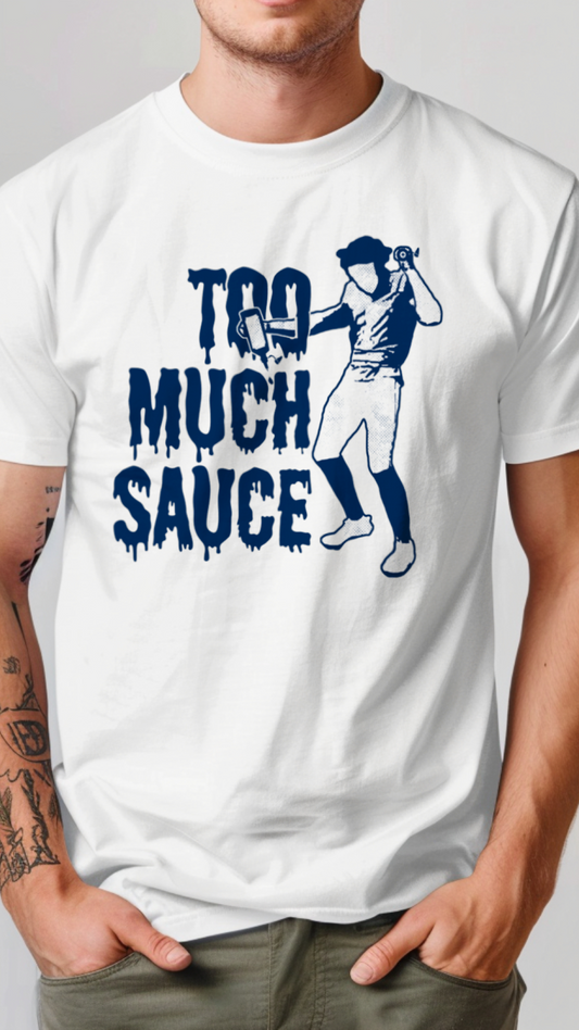 White t-shirt with blue graphic and text 'Too Much Sauce' worn by a person on a plain background