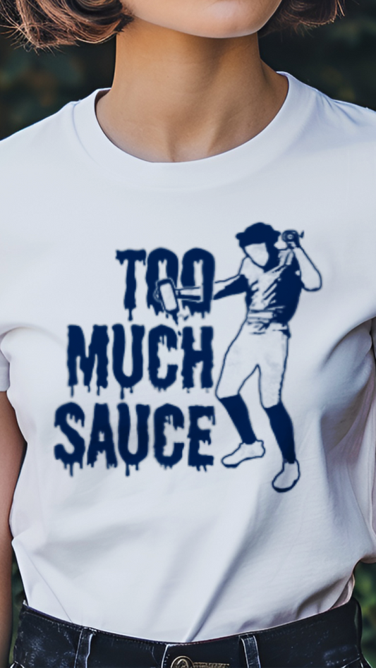 Person wearing a white t-shirt with a graphic and text 'Too Much Sauce' in a garden setting