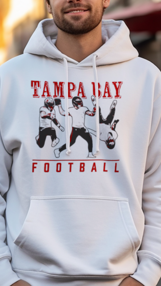 Man wearing a white hoodie with 'Tampa Bay Football' design on a street.